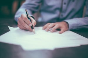 Image of person writing "Is Contract-To-Hire A Win-Win For Both Parties? What To Consider" from ESP IT technology staffing firm in Twin Cities, MN.