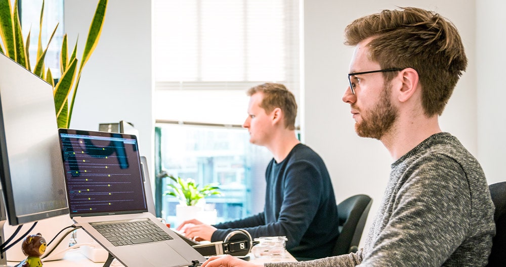 IT Pros working in front of a computer