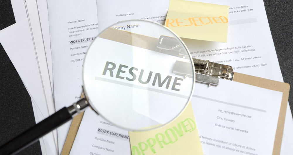 Image of a magnifying glass over resume