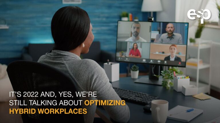 A woman at her desk during a remote meeting with text It’s 2022 and, Yes, We’re Still Talking About Optimizing Hybrid Workspaces - ESP IT